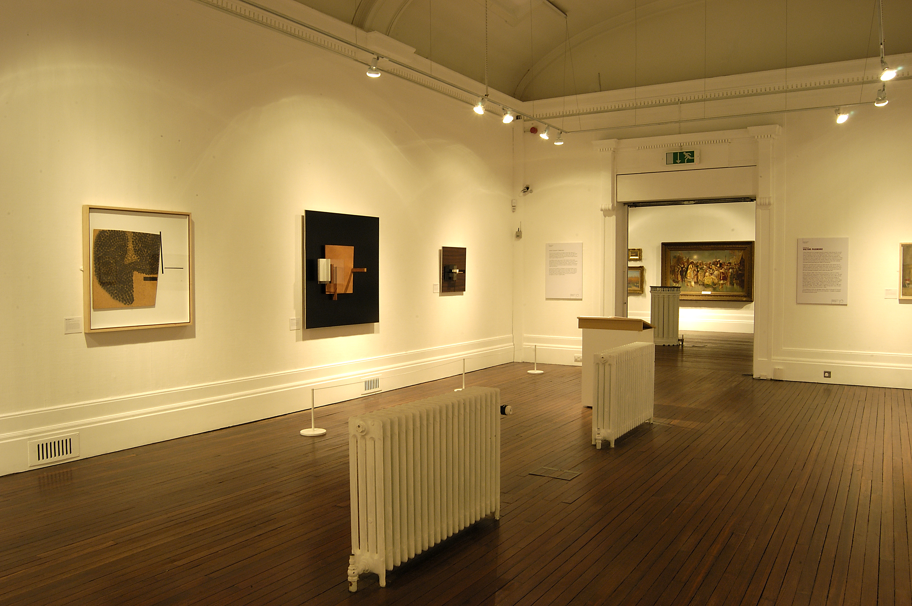 Artworks by artist Victor Pasmore. The artworks displayed are collages of small wooden sheets and blocks. Included in the exhibition Victor Pasmore: From The arts Council Collection.