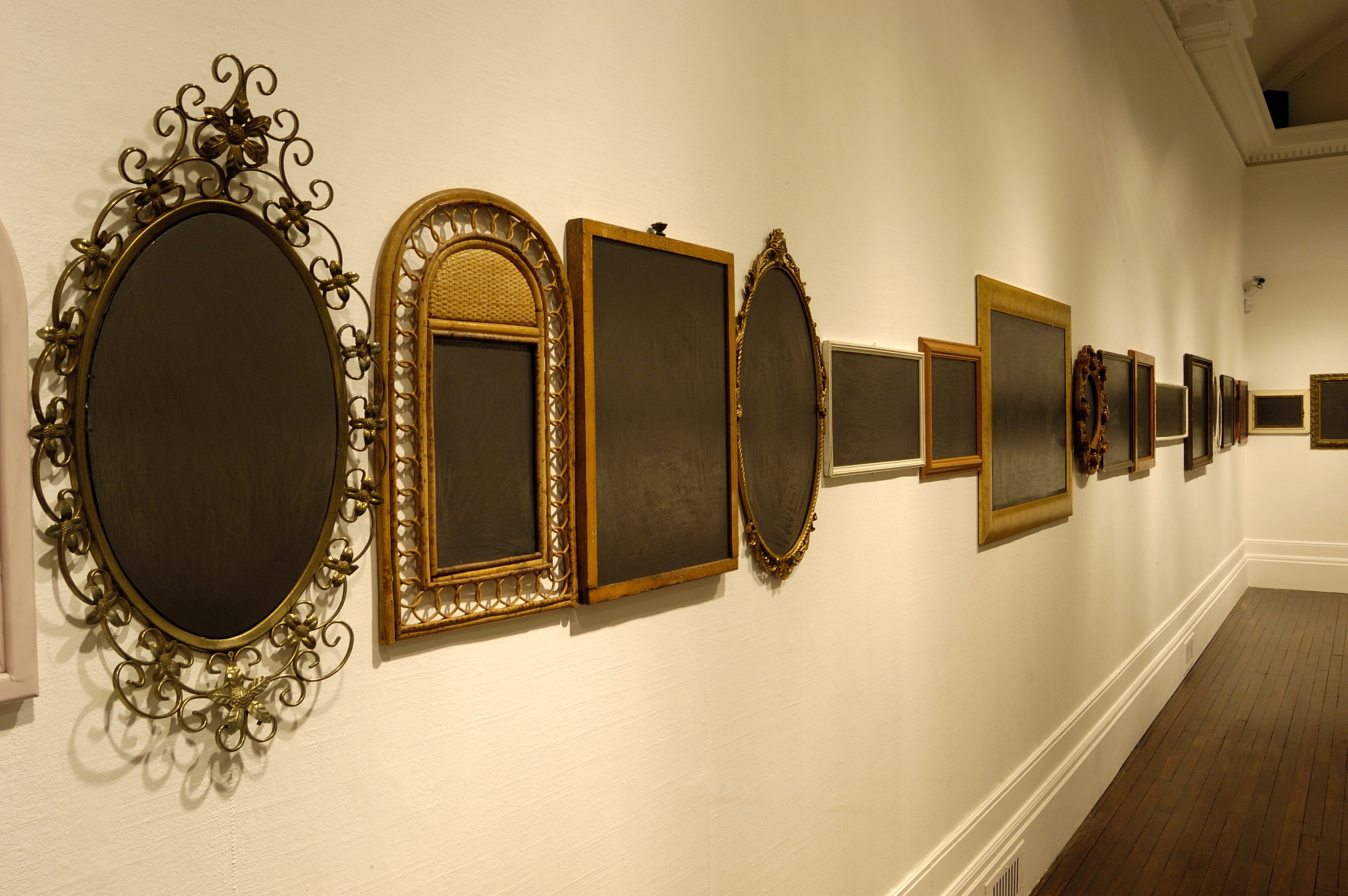 Mirrors in frames, the reflective glass of the mirrors has been obscured by grey graphite to create an opaque surface. The artworks are by artist Jordan McKenzie and were included in the exhibition Dark Mirror.