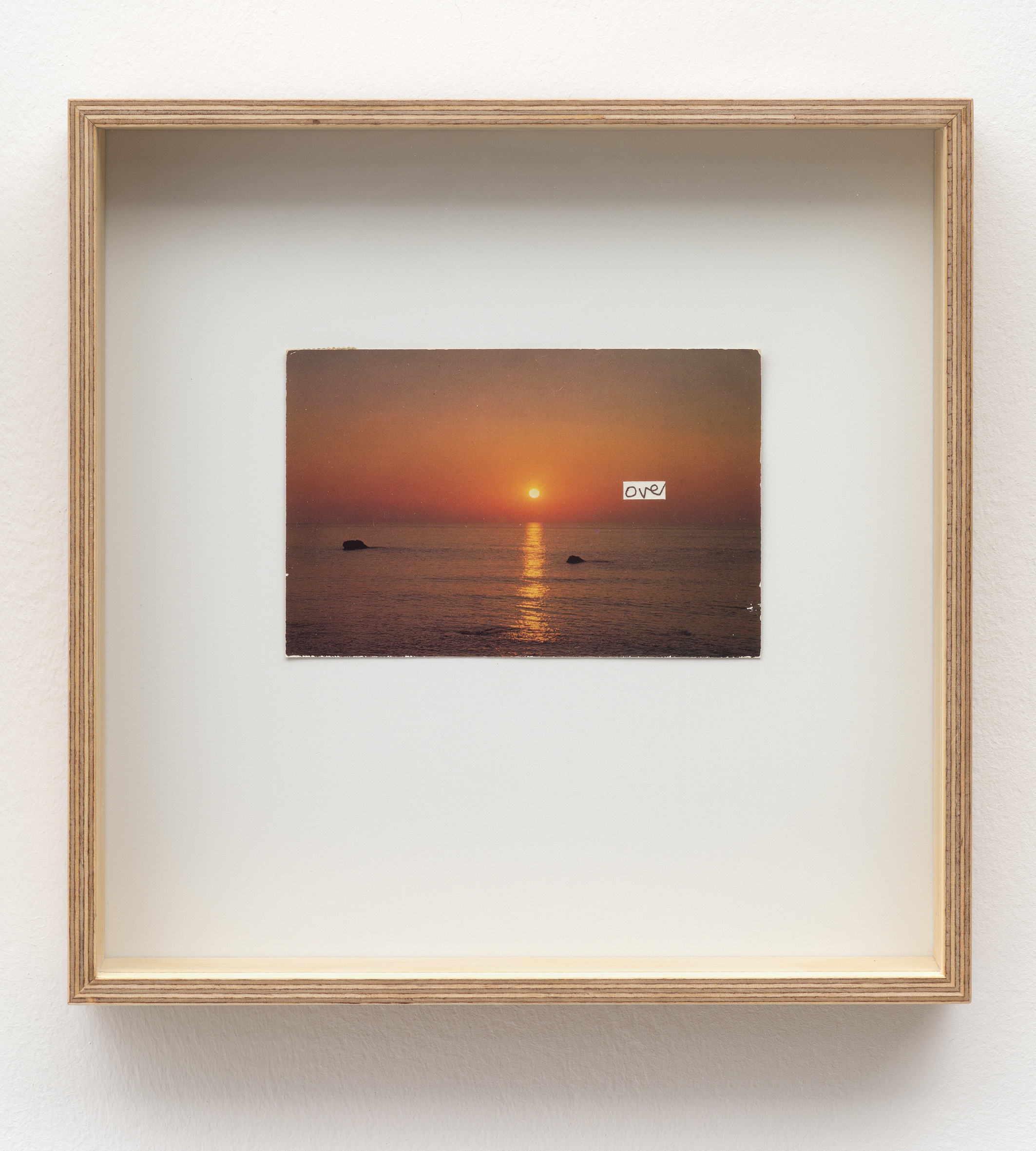 Altered postcard. The postcard by artist Roy Voss is of a sunset with the word over written in small white section in ballpoint pen. Included in the exhibition Roy Voss: All The World’s A Sunny Day.