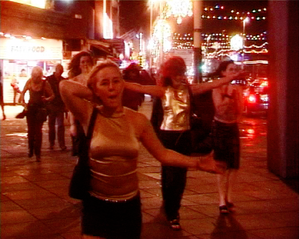 Image from the film Pleasure Beach by artist Nina Könneman that records the nightlife of Blackpool. The image is of a group of women walking down Blackpool’s promenade